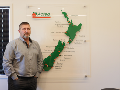 Aotea Security image of person to the left of map of New Zealand with pins of company locations
