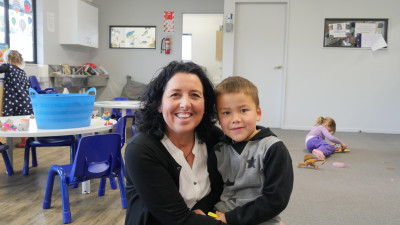 Crackerjax image of staff holding a child