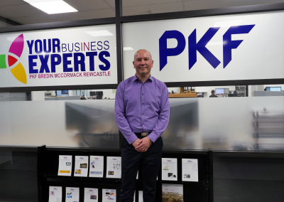 PKF Bredin McCormack Rewcastle image of person in front of company sign